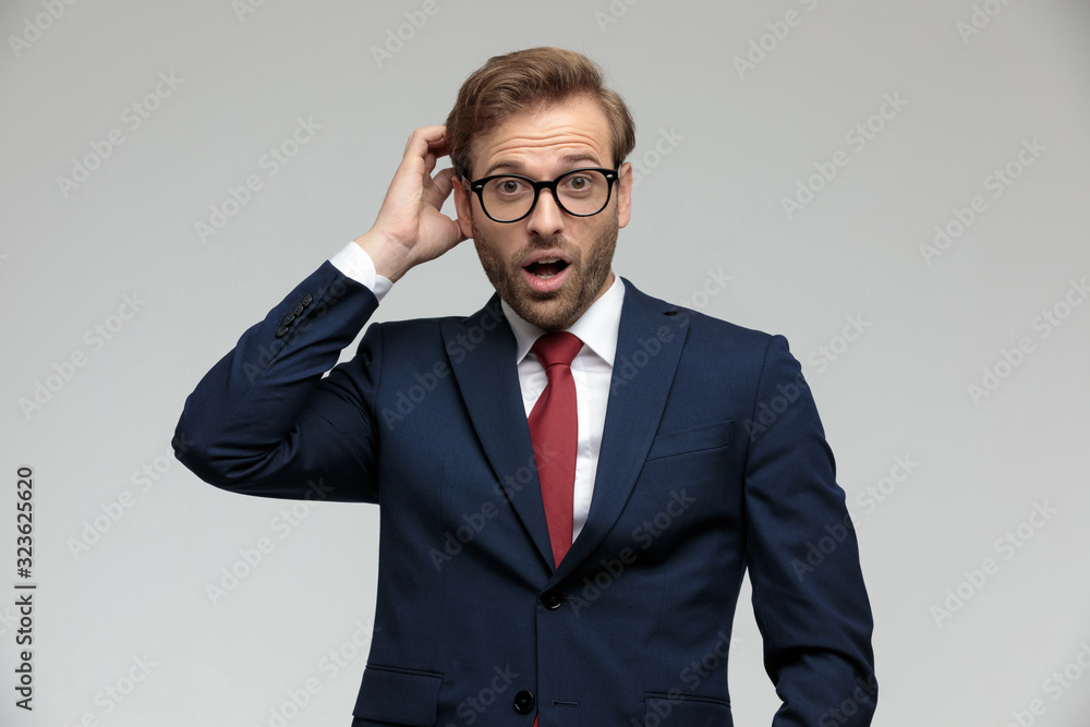 businessman standing and scratching his head shocked businessman standing and scratching his head shocked