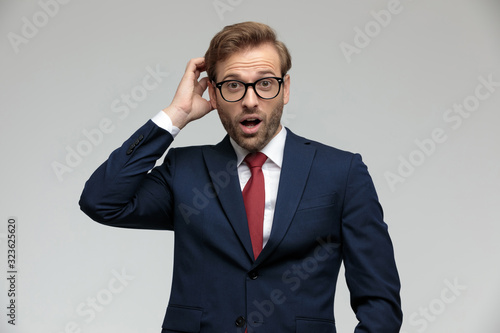 Fotografie businessman standing and scratching his head shocked