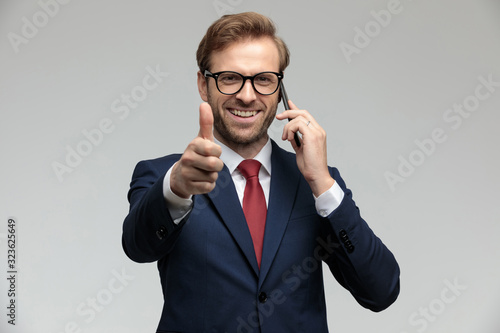 businessman standing and giving a thumbs up happy