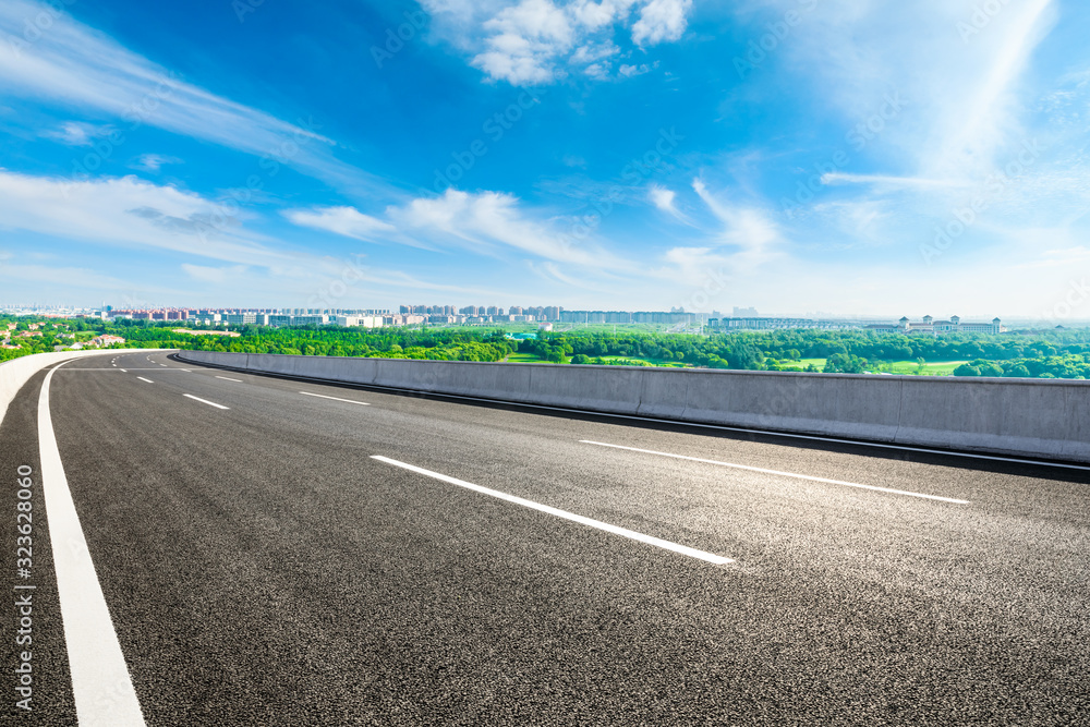 Fototapeta premium Empty asphalt highway and city suburb skyline on a sunny day in Shanghai.