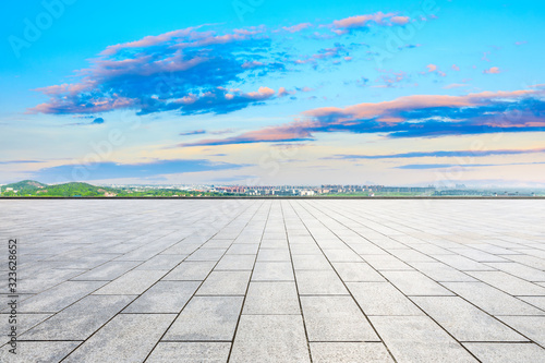 Empty square floor and city suburb skyline at sunset in Shanghai.