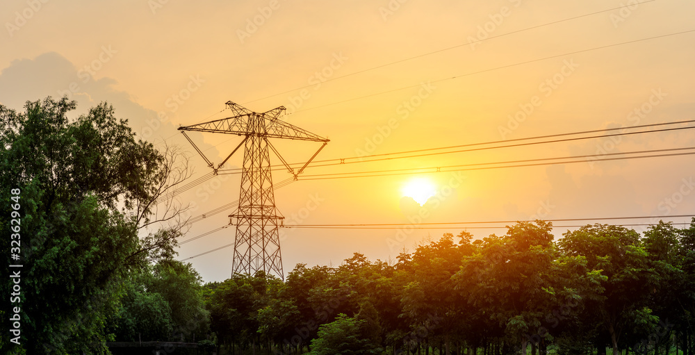 High voltage electricity tower and sunset sky landscape