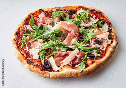 Gourmet prosciutto ham and rocket Italian pizza
