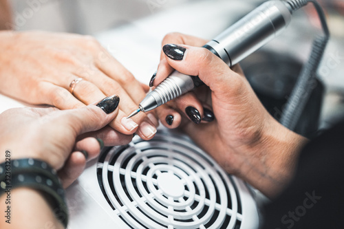 Closeup shot of hardware manicure in a beauty salon.