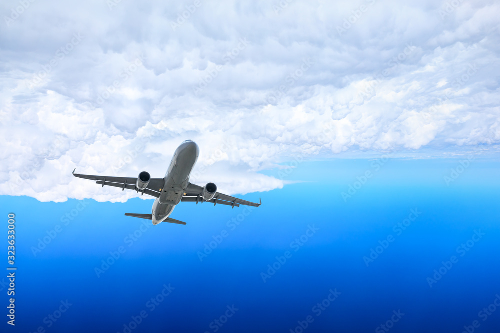 Naklejka premium Airplane flying at high altitude and beautiful high-altitude clouds in spring