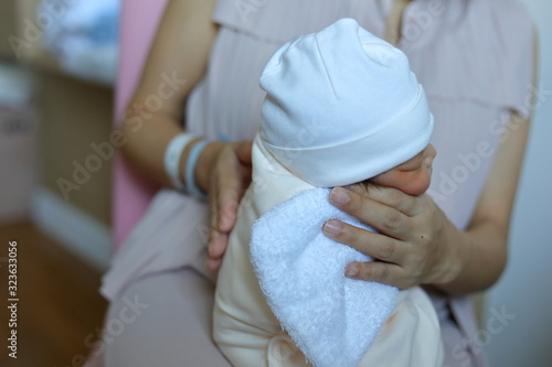 mother parenting, mom using hand help a baby newborn belch burping after breastfeeding milk