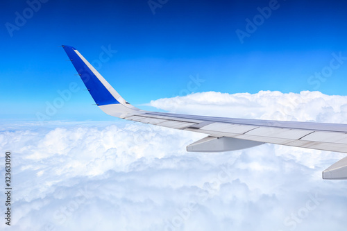 Airplane flying at high altitude and beautiful high-altitude clouds in spring
