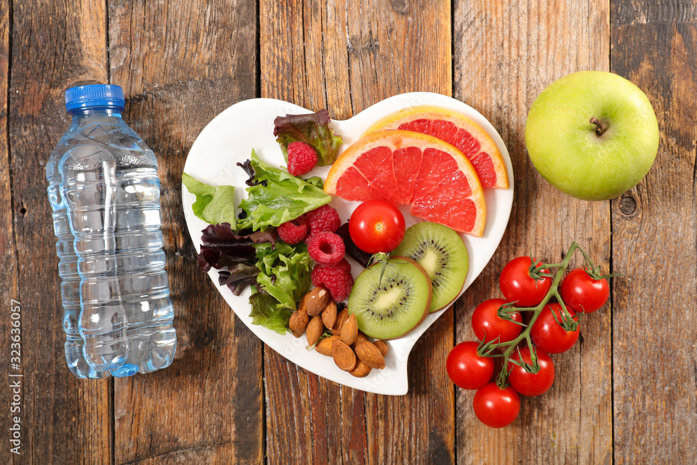 diet food concept with fruit, almond, apple and water bottle - obrazy, fototapety, plakaty 