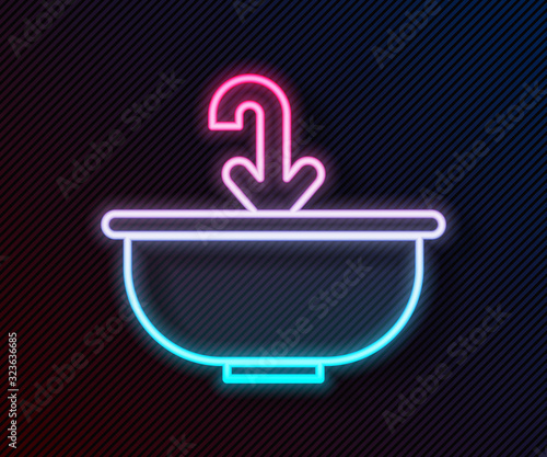 Glowing neon line Washbasin with water tap icon isolated on black background. Vector Illustration