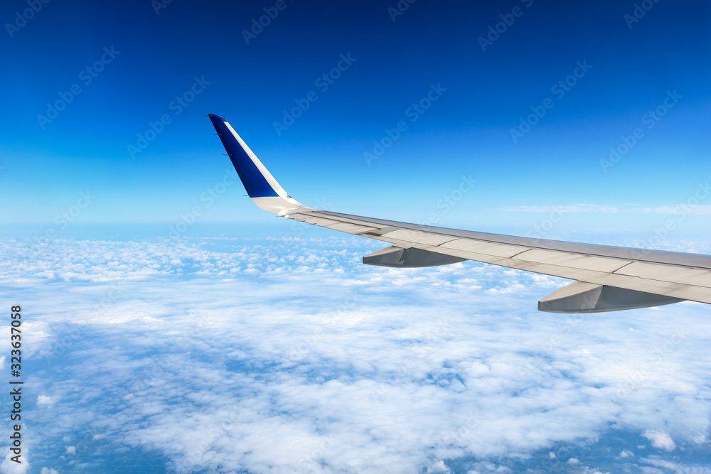 Fototapeta premium Airplane flying at high altitude and beautiful high-altitude clouds in spring