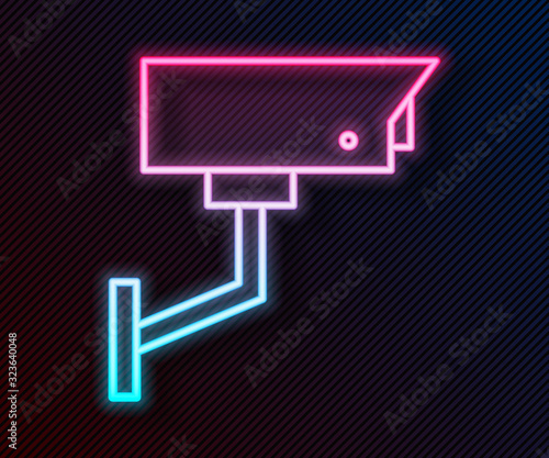 Glowing neon line Security camera icon isolated on black background. Vector Illustration