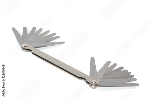 Stainless steel double end feeler gauge on white background
