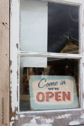 Sign with: come in  we're open. Historic gasstation at Burkes Pass South Island New Zealand Oldtimer cars photo