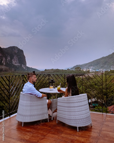 Photography couple watching sunset from rooftop bar in Krabi Thailand