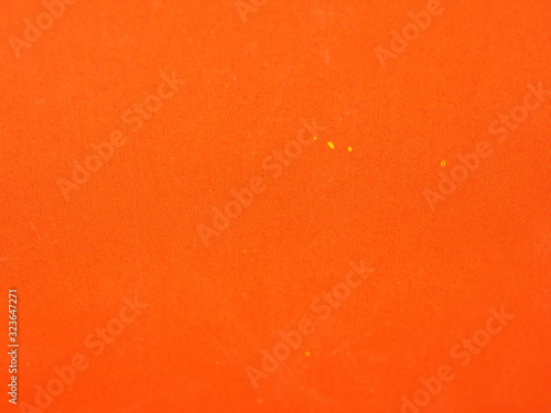 Orange colored paper background texture. Grunge image.
