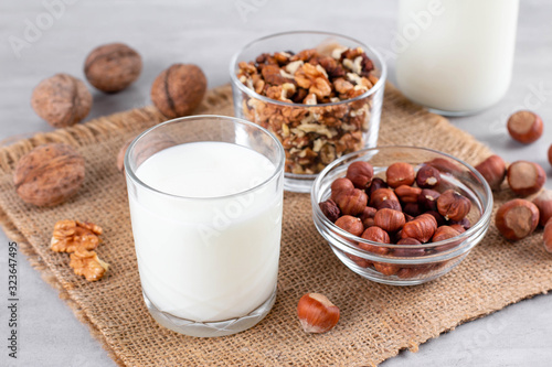 Vegan milk from nuts in glass jar with nuts