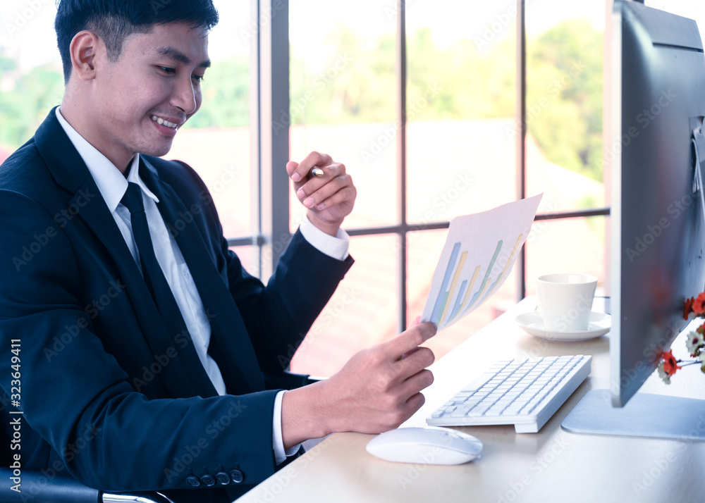Businessman with graph paper at office workplace. Businessman with graph paper at office workplace.