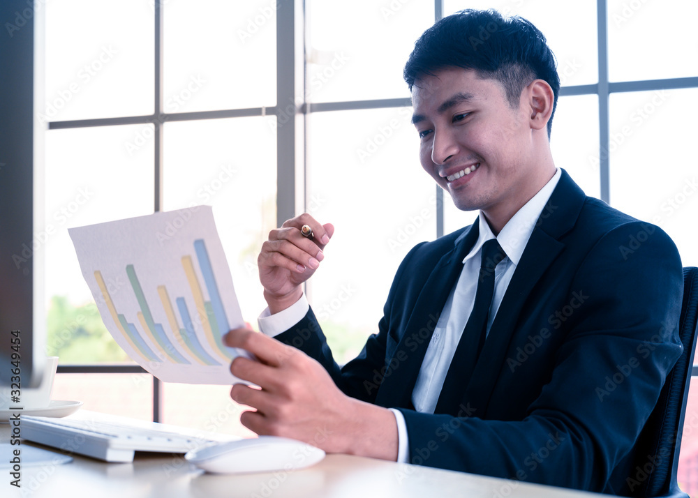 Businessman with graph paper at office workplace. Businessman with graph paper at office workplace.