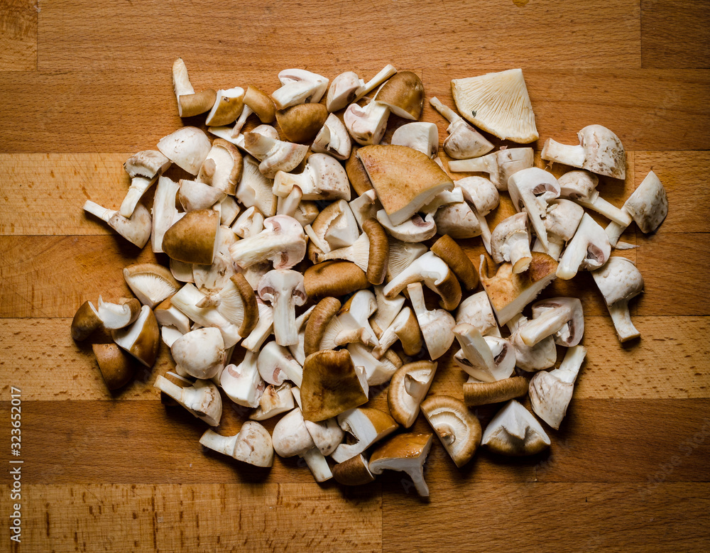 Chopped mushrooms on wooden board Chopped mushrooms on wooden board