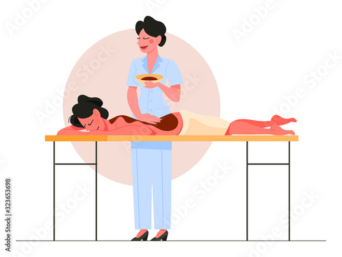 Woman making massage with chocolate for a client.