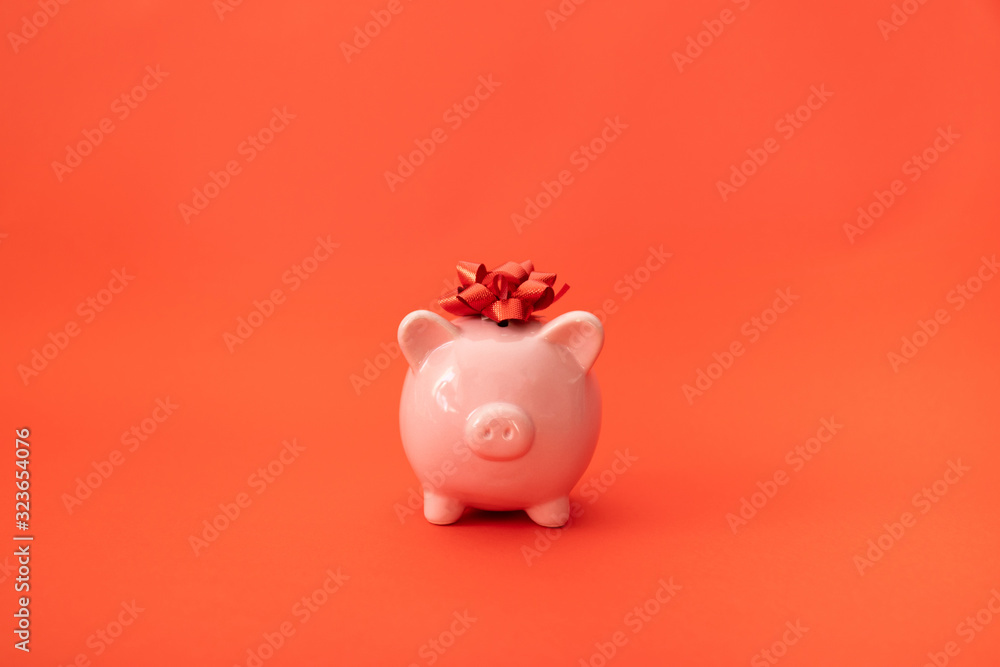 Pink piggy bank on a red background. Investment and Savings Recipe