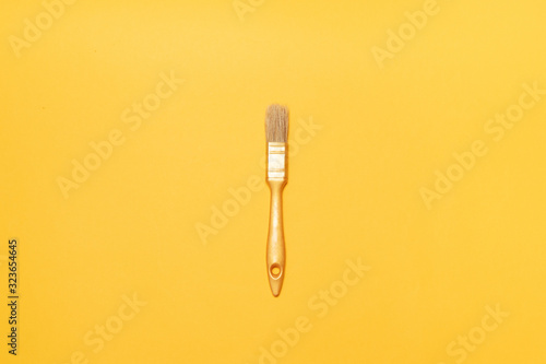 Gold brush for drawing on a yellow background