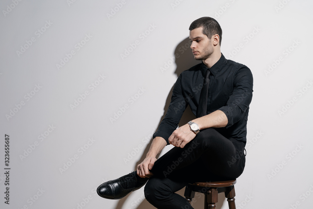 Young handsome businessman in black shirt and black suit Young handsome businessman in black shirt and black suit