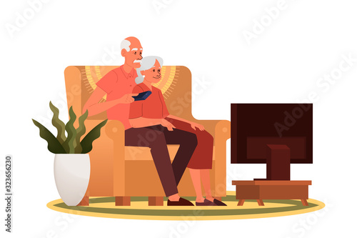 Old couple sitting on sofa and watching TV. Grandfather and grandmother