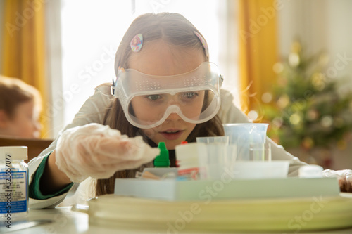 Close up of girl focusing on completing her experiment