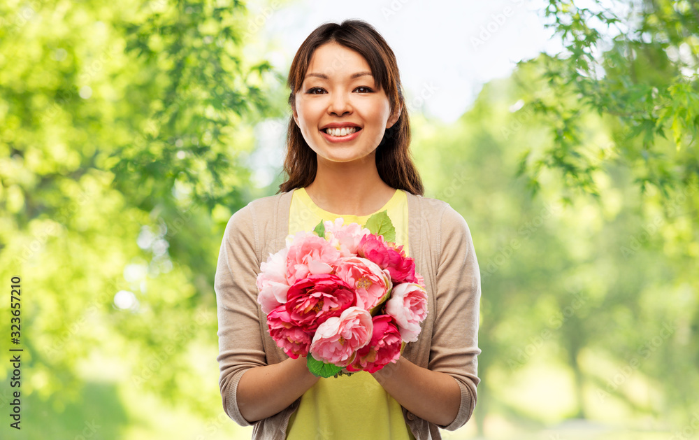people and international women's day concept - happy asian young woman with bunch of peony flowers over green natural background people and international women's day concept - happy asian young woman with bunch of peony flowers over green natural background