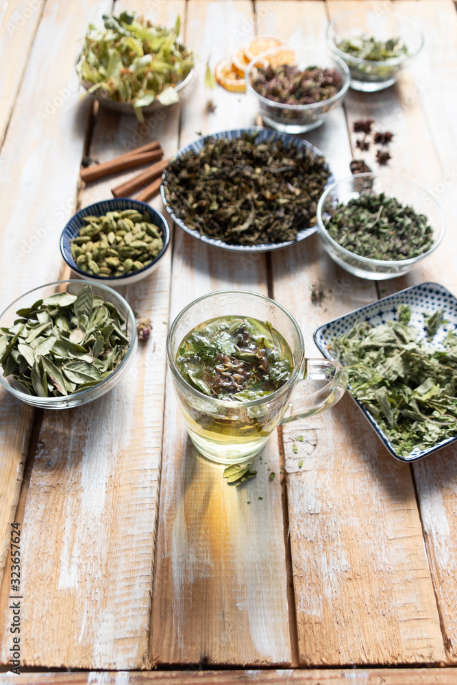 Natural medicine in cup with herbal and spices tea on wooden background Natural medicine in cup with herbal and spices tea on wooden background