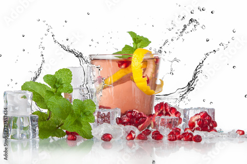 summer pomegranate drink with lemon and mint with splashed water and ice photo