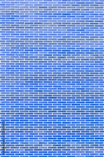 real wall made of solid blue bricks, in vertical plane