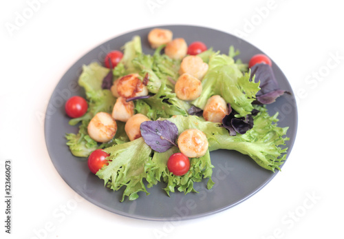Seafoods - Shrimps, Sea Scallops, Squids and Salmon. Garnished with Fresh Raw Salad Leaf.
