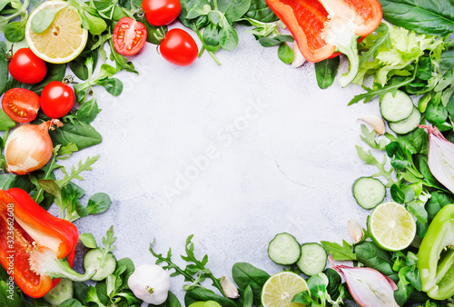 Healthy food background with various green herbs and vegetables. Ingredients for cooking salad. Vegetarian and vegan food concept. Top view  copy space