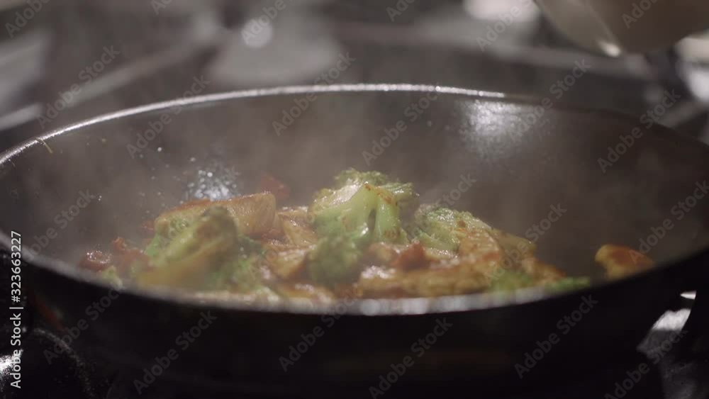 Preparation of chopped turkey meat with fresh broccoli and dried tomatoes in the kitchen Preparation of chopped turkey meat with fresh broccoli and dried tomatoes in the kitchen