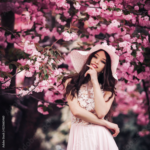 portrait of a romantic girl in sakura garden
