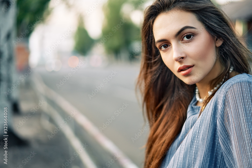 Close up young beautiful woman portrait posing in the city street Close up young beautiful woman portrait posing in the city street
