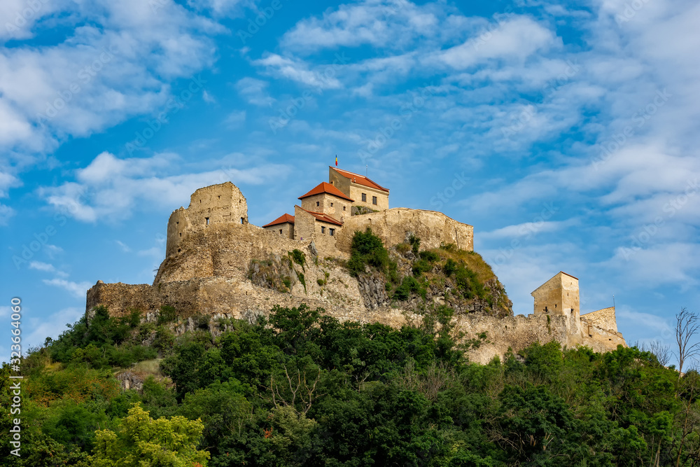 Beautiful view of the Rupea Stronghold Fortress on a blue sky with white clouds, Rupea, Brasov, Romania