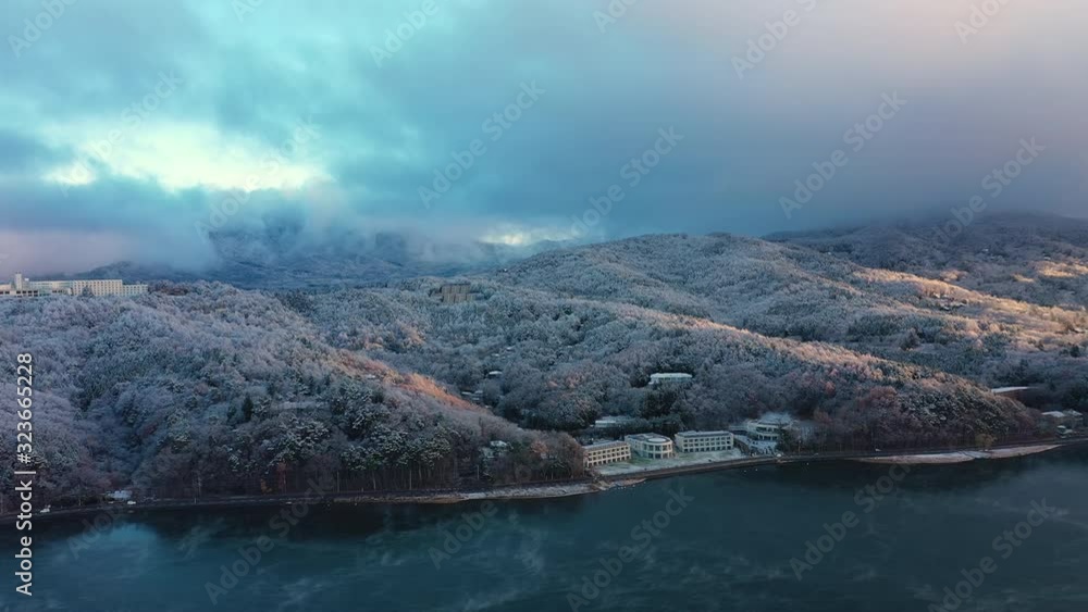 Aerial view of lake Yamanaka near Mount Fuji, winter scenery with freezing fog on trees during sunrise - landscape panorama of Japan from above, Asia Aerial view of lake Yamanaka near Mount Fuji, winter scenery with freezing fog on trees during sunrise - landscape panorama of Japan from above, Asia