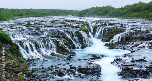 Panoramical view of famous Bruarfoss waterfall with blue water in summer time. Iceland, Europe