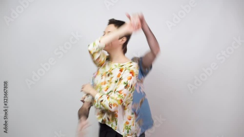 Swing dancers wearing hawaiian shirts on white background. Man and woman are dancing boogie woogie dance. Happy couple dancing. Social dance concept.