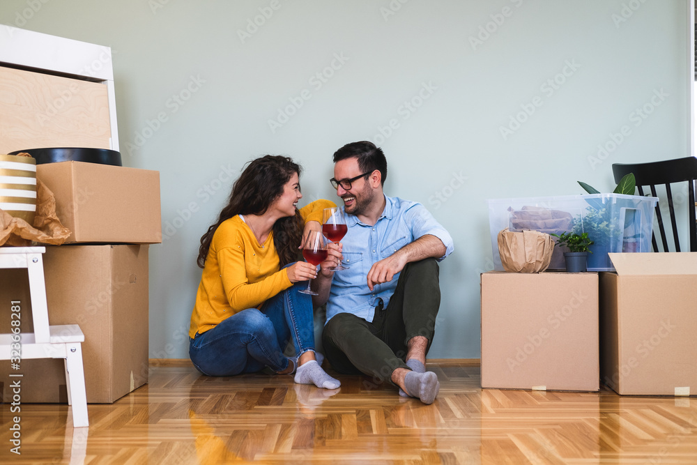 Cheers to new beginnings stock photo. Shot of a happy couple having wine to celebrate moving into new home Cheers to new beginnings stock photo. Shot of a happy couple having wine to celebrate moving into new home