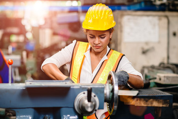 Girl teen worker african american working labor in industry factory with heavy steel machine.