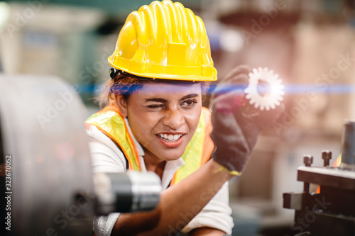 Obraz na plátně engineer worker looking at steel gear part, working precise and most accuracy high performance doing best job
