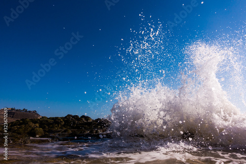 Fototapeta Naklejka Na Ścianę i Meble -  A surge of surf waves on a rocky shore