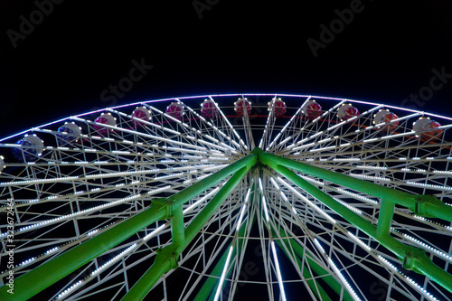 Colorful ferris wheel in the city park at night.