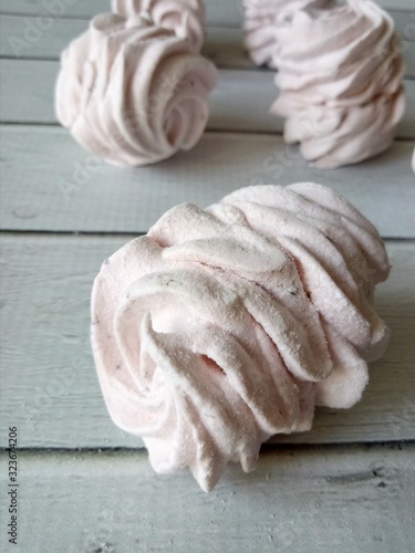  tasty marshmallows on white wooden table Close-up