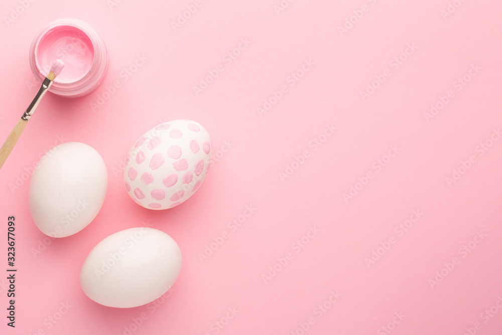 Pink painted easter eggs and paint brushes with copyspace. Easter holiday concept.