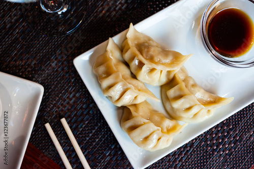 Japanese tasty dumplings gyozas with soy sauce photo